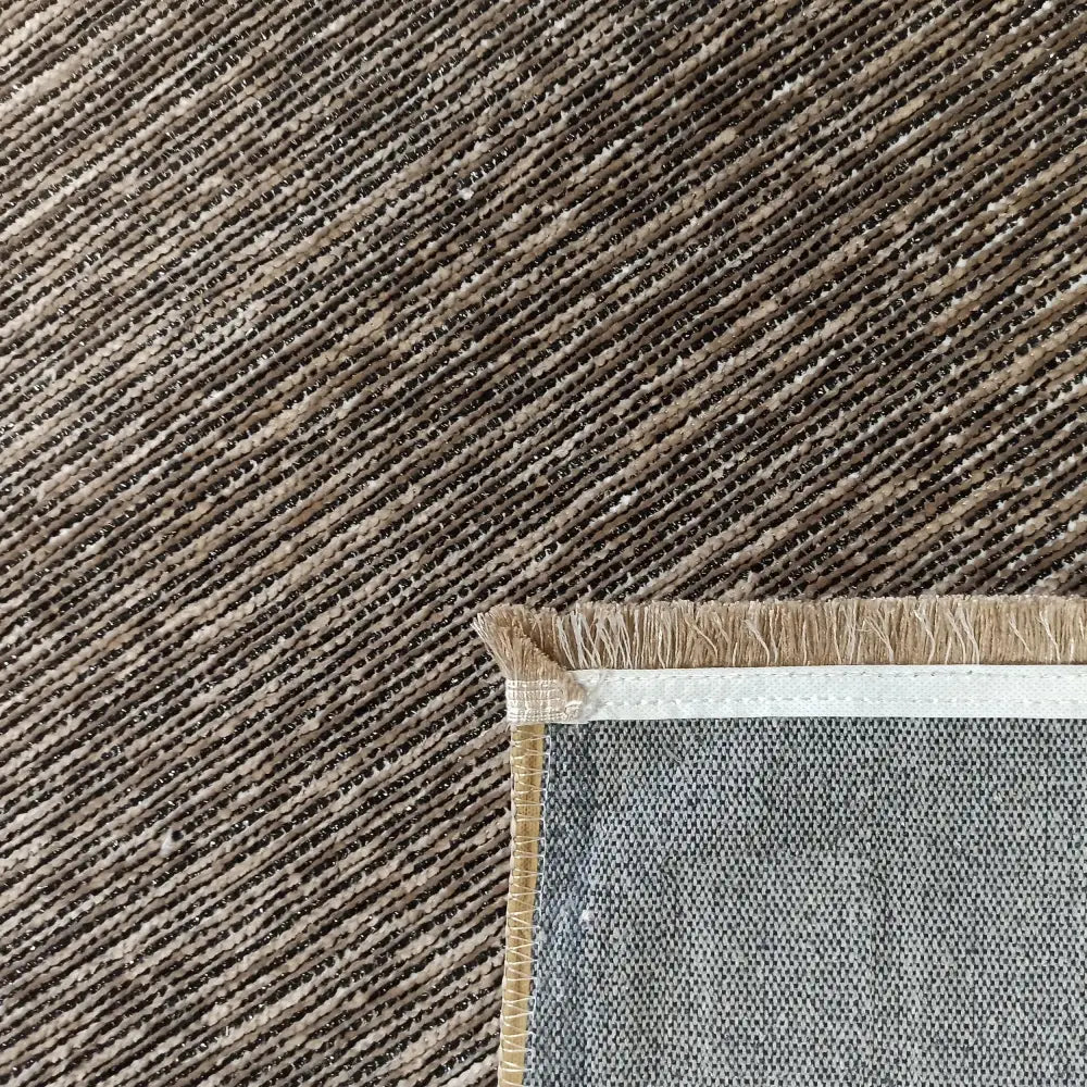 Tepe Diamond-teppe i beige, nærbilde av diagonale striper, synlig hjørne med frynser og forsterket kant.