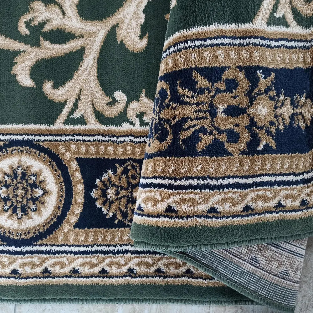 Tepe Eksklusiv teppe i grønn og beige, nærbilde som viser ornamentmønster og vevd bakside.