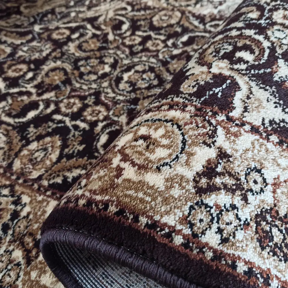 Tepe Eksklusiv teppe, detaljert nærbilde av bøyd hjørne som viser tekstur, kantfinish og orientalsk mønster.