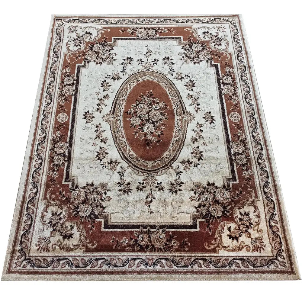 Tepe Eksklusiv 04 N teppe, sett ovenfra med ovalt midtmotiv og detaljerte blomster i brune og beige nyanser.