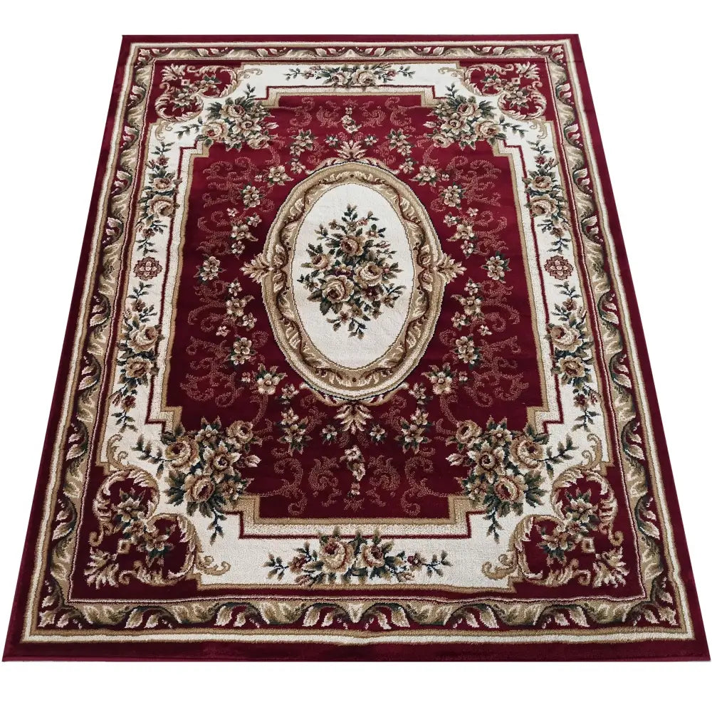 Tepe Eksklusiv 04 N teppe i burgunderrosa, klassisk blomstermønster og kremfargede ornamenter sett ovenfra.