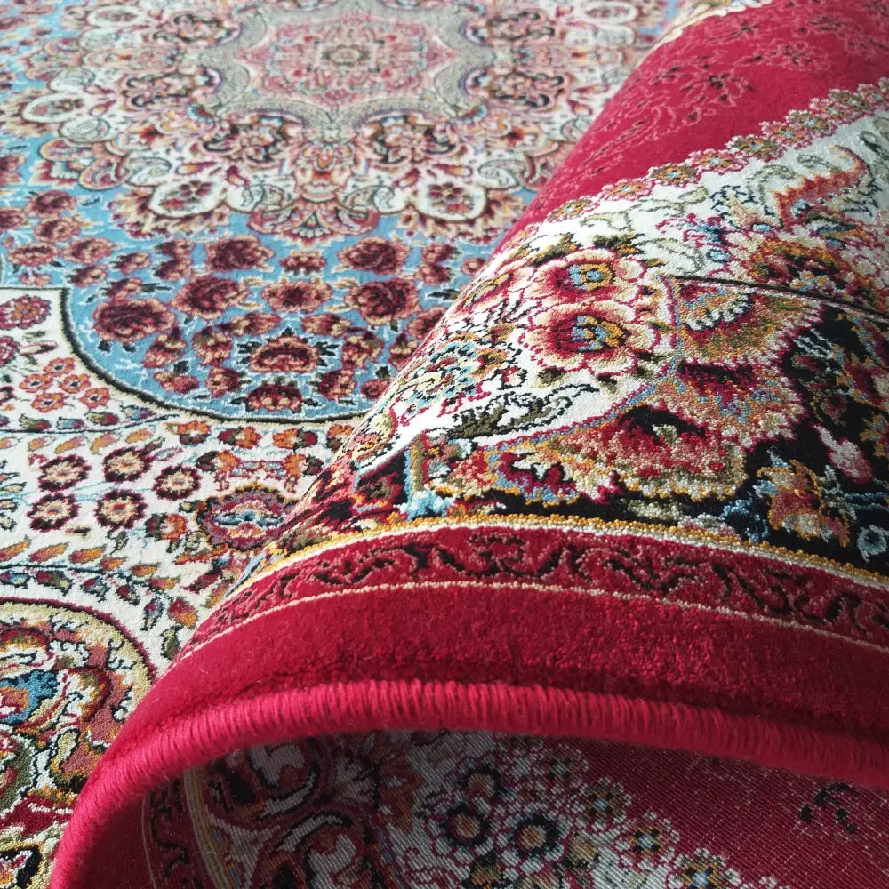 Tepe Eksklusiv Pers 04 teppe, nærbilde av hjørnet brettet opp som viser tykkelse og detaljer i mønsteret.