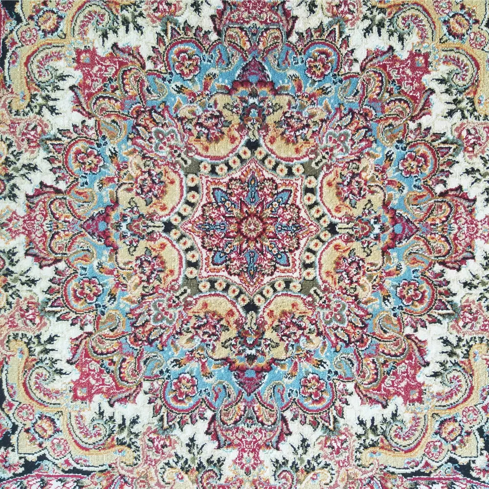 Tepe Eksklusiv Pers 10 teppe, nærbilde av midtens blå og røde medallion med detaljerte orientalske mønstre.