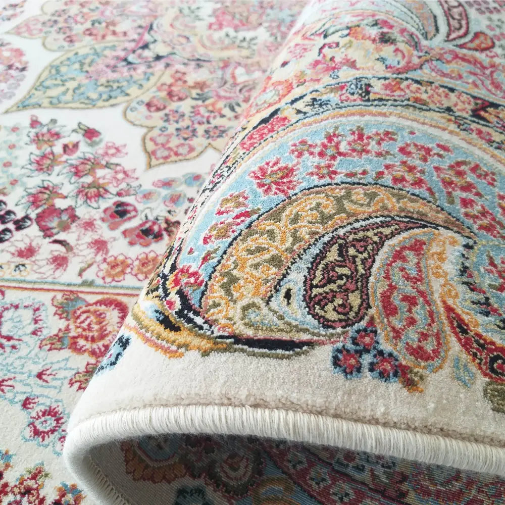 Tepe luksuriøst persisk teppe i krem, nærbilde av hjørne med detaljert orientalsk mønster og synlig tekstur.