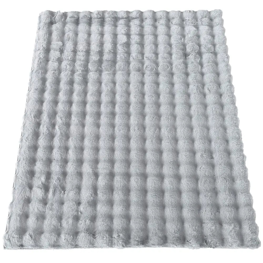 Tepe Merlin 3D grått teppe 160 x 200 cm, sett ovenfra, viser myk, fluffy overflate og rutete struktur.
