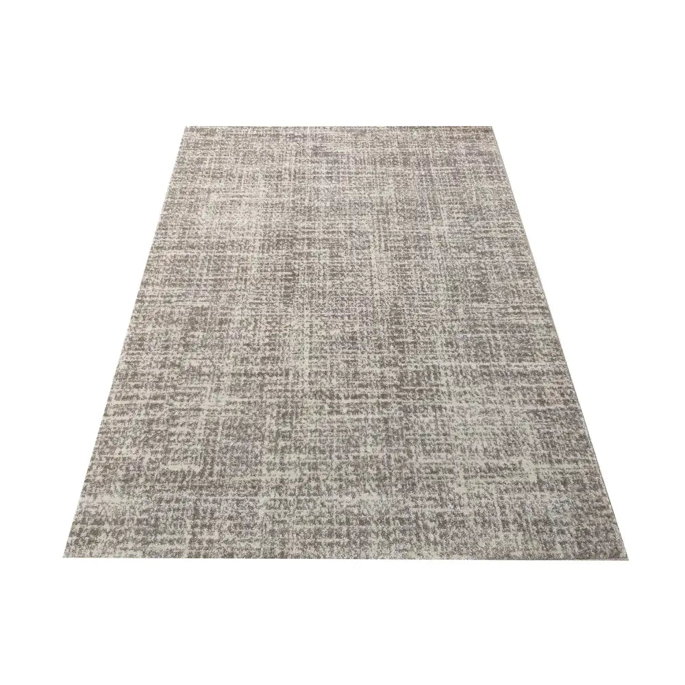 Tepe Moderne Vista 06 teppe i grå og beige nyanser, rutete melering sett fra skrå vinkel mot hvit bakgrunn.