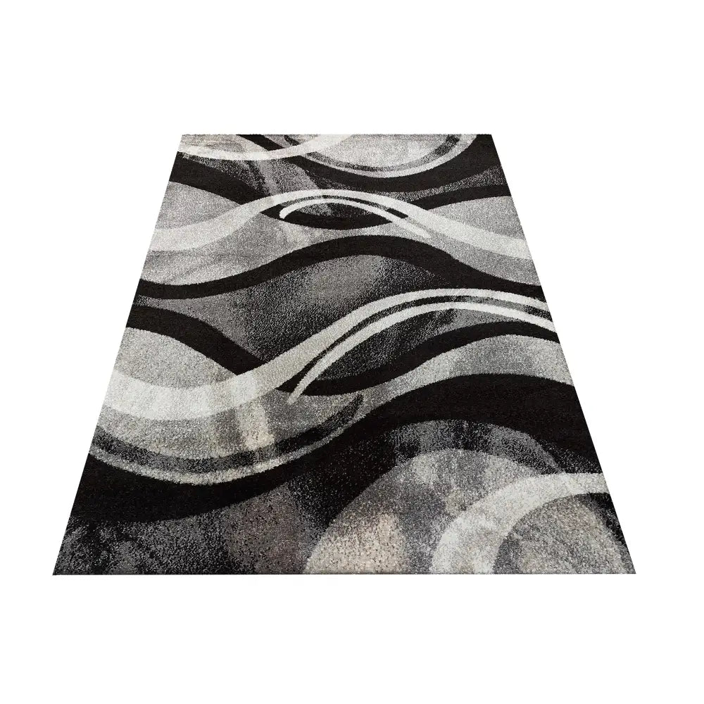 Tepe Otto 01 grått teppe 240 x 330 cm, skrå oversiktsvinkel viser bølgede svarte, grå og hvite mønstre.