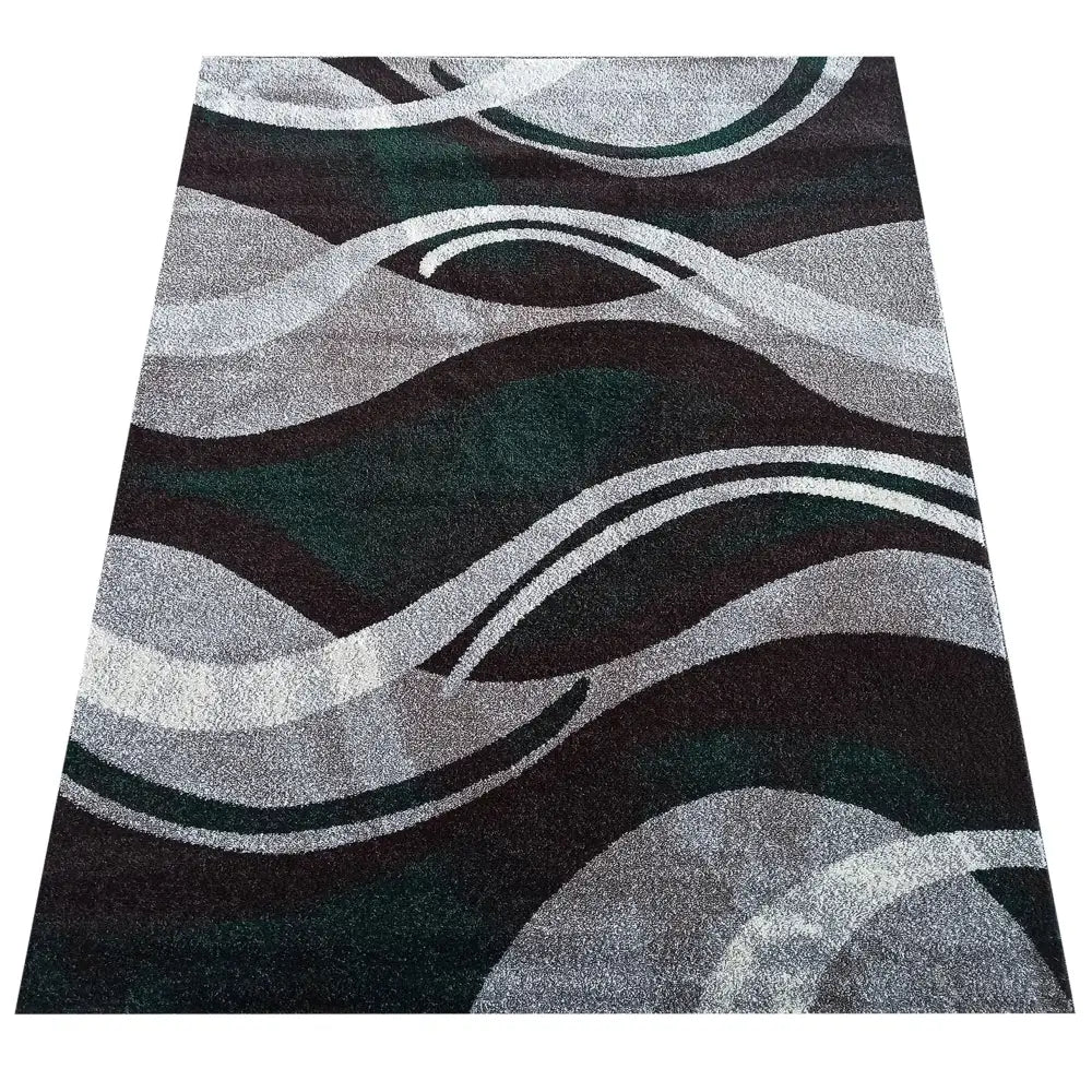 Tepe Otto 01 teppe i grå-grønt, sett skrått ovenfra med bølgende mønster i svart, hvitt og mørkegrønt.