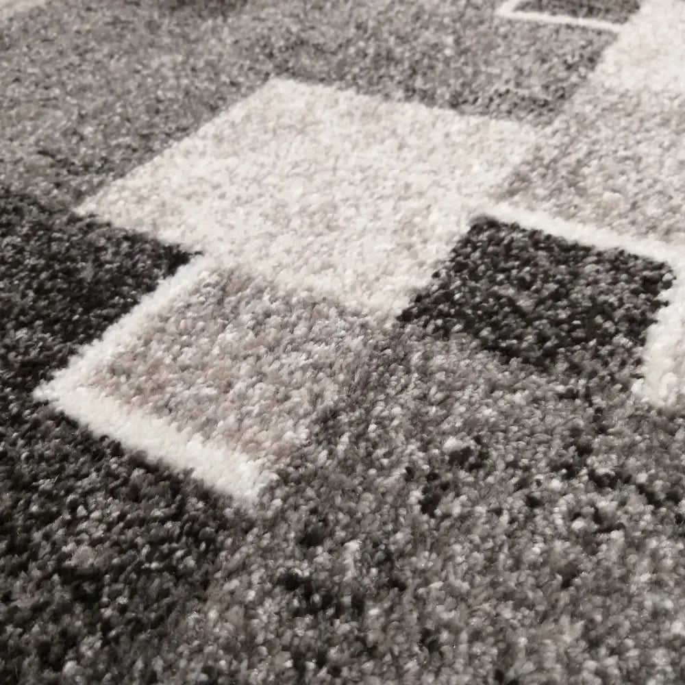 Tepe Panamero teppe i grå, nærbilde som fremhever lodden tekstur og geometriske mønster i flere nyanser.