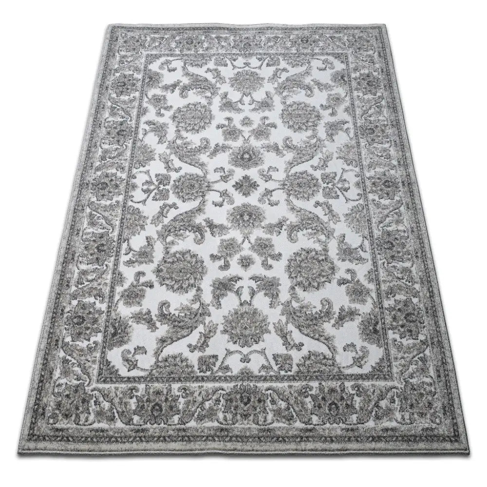 Tepe PURITY 01 grått teppe 120x170 cm, skrå oversikt som fremhever blomstermønster og dekorativ kant.