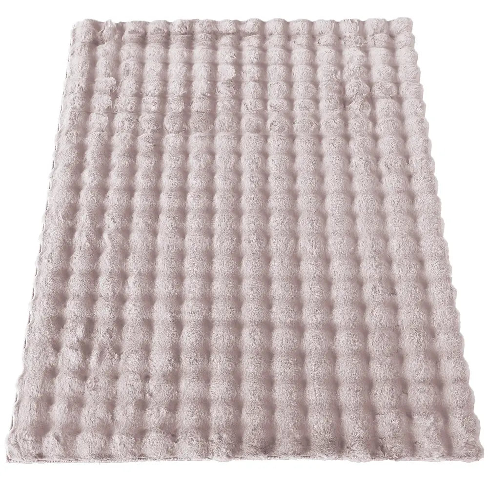 Tepedesign Merlin 3D rosa, rektangulært plysjteppe med forhøyet rutemønster, sett ovenfra.