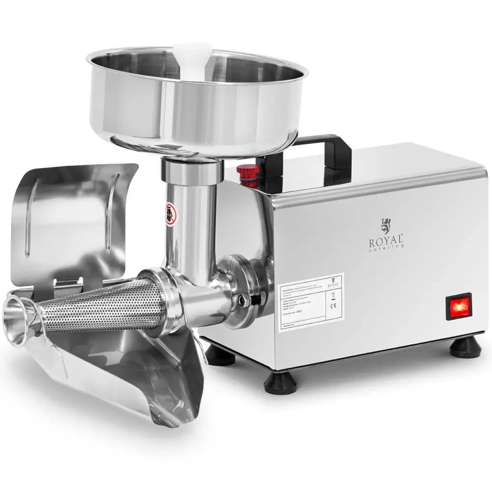 Tomat- og grønnsakspuremakermaskin, skrå frontvisning med stor beholder, perforert utløpsrør og rød av/på-knapp.