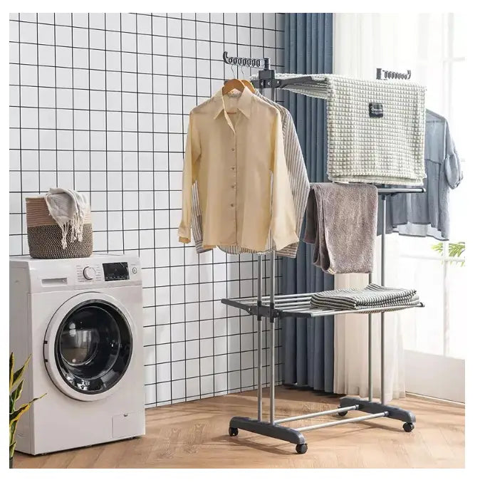 Tørkestativ for klær XXL, sett fra siden med våte klær og håndklær ved vaskemaskin på flislagt vegg.