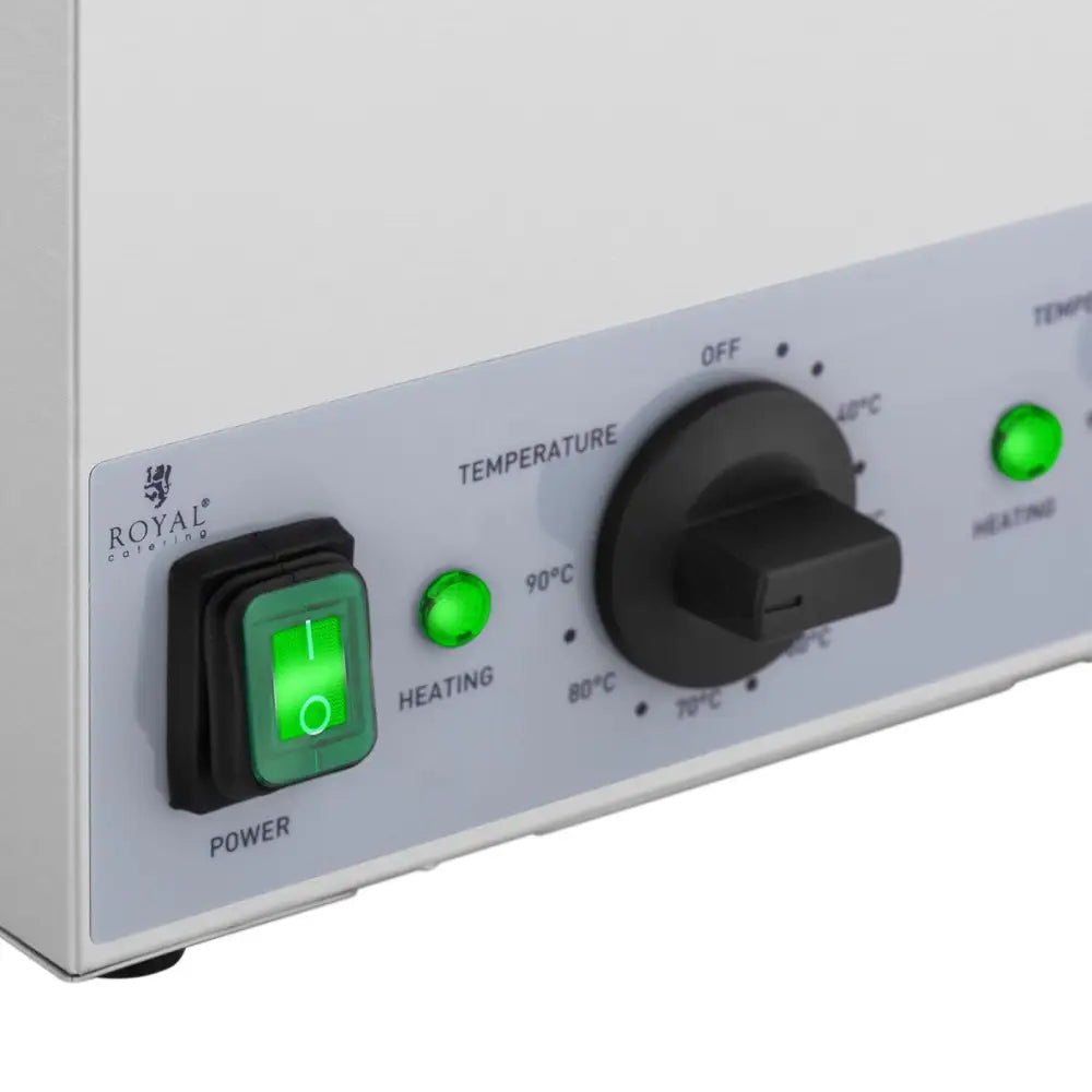 Tremannsflaskevarmer, nærbilde av hvitt betjeningspanel med grønn bryter, temperaturvelger og indikatorlamper.