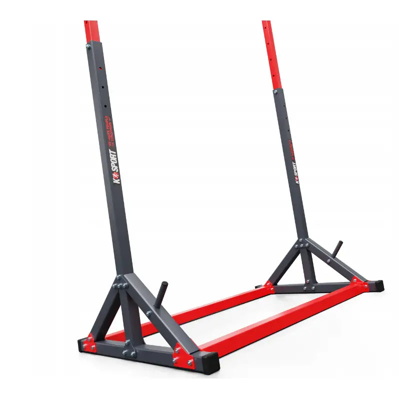 Treningsstang stasjonær, nærbilde av justerbare stålstolper og solide boltefester i rød og mørk grå finish.