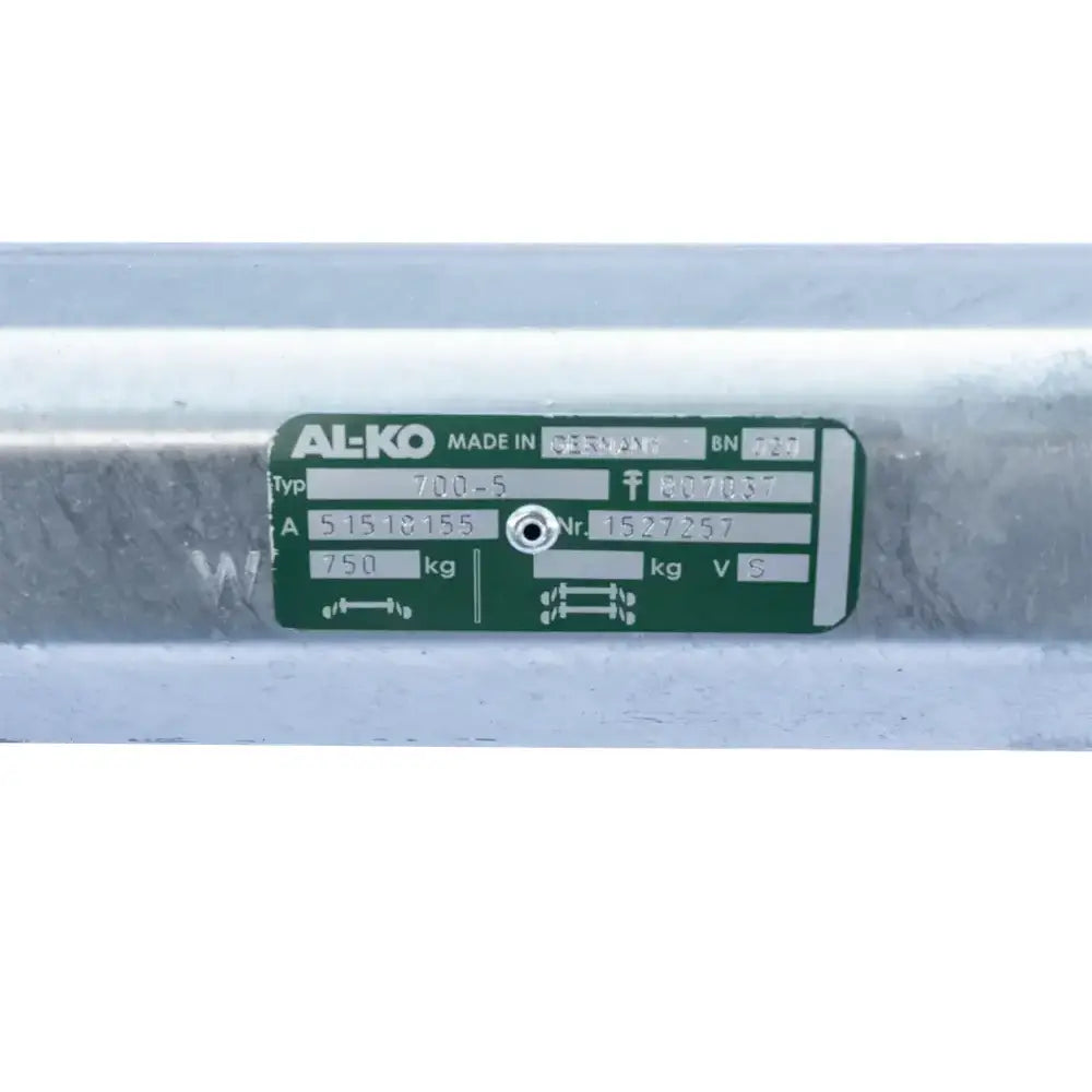 Aksling tilhenger AL-KO, nærbilde av etikett med tekniske spesifikasjoner på grønn bakgrunn festet til metall.