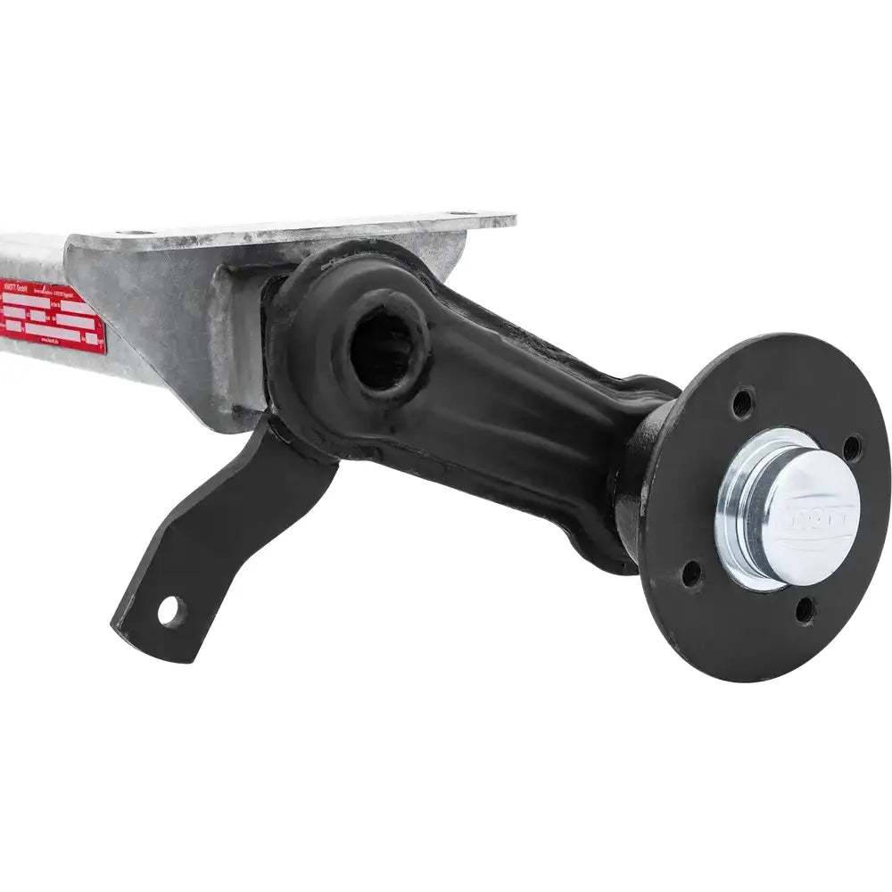 Aksling for tilhenger Knott VG7-L, sidevisning med fokus på hjulnav, monteringsplate og røde merkingsetiketter.