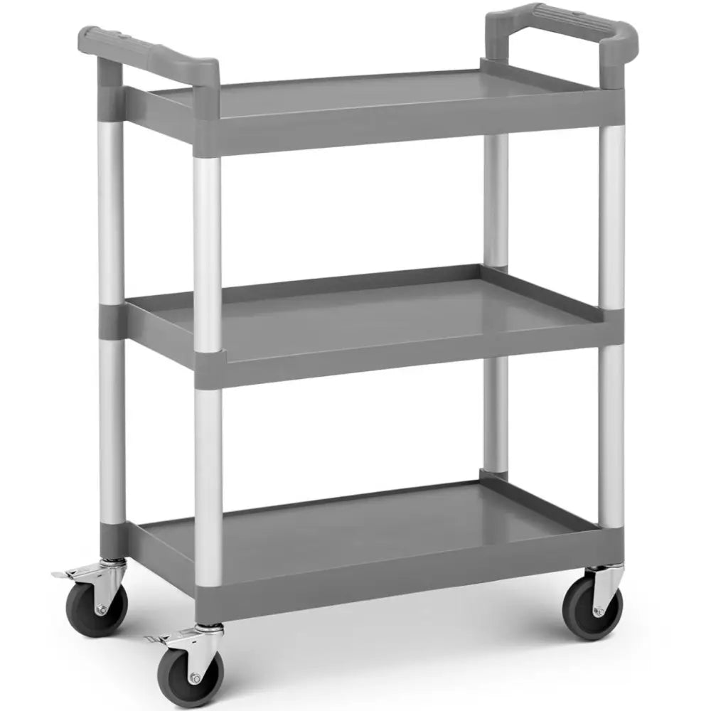 Universell vogn med tre grå plast hyller, sølvfargede bein og bremsehjul, sett fra skrå vinkel med håndtak.