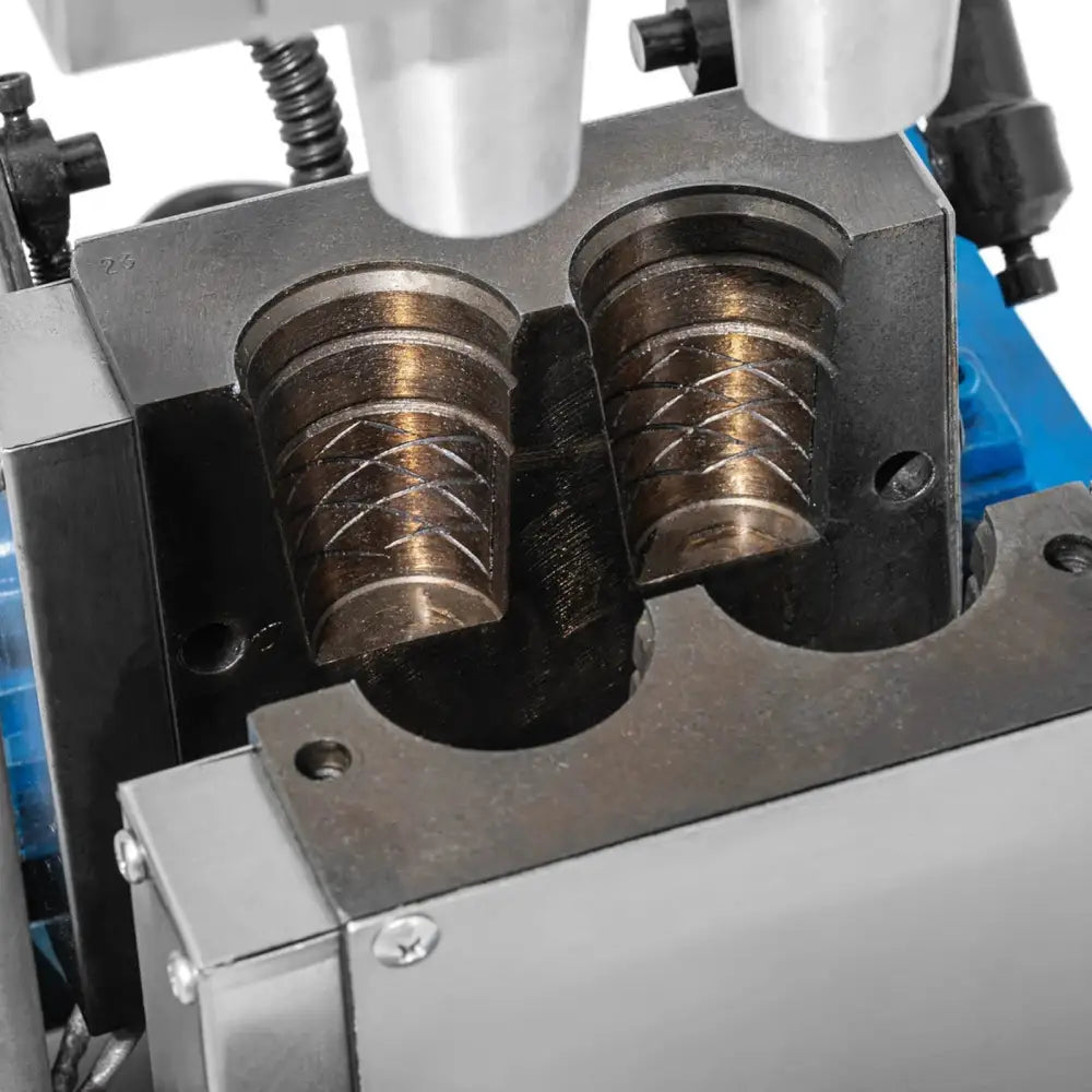 Vaffeljern for iskremkjeks, nærbilde av to gravert mønstrede sylindervalsers detaljer i stålmaskin.