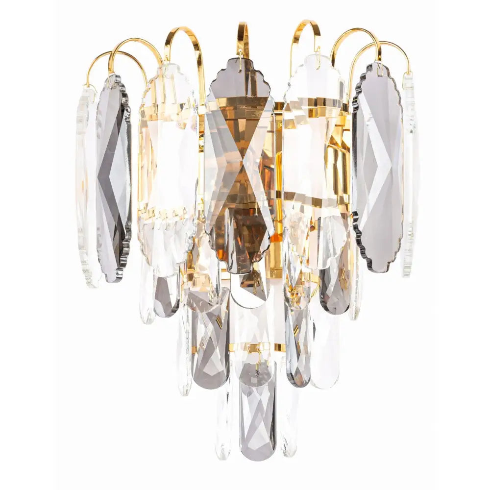 Vegglampe med klare og røykfargede glassprismer, gullfargede detaljer, frontvisning mot hvit bakgrunn.