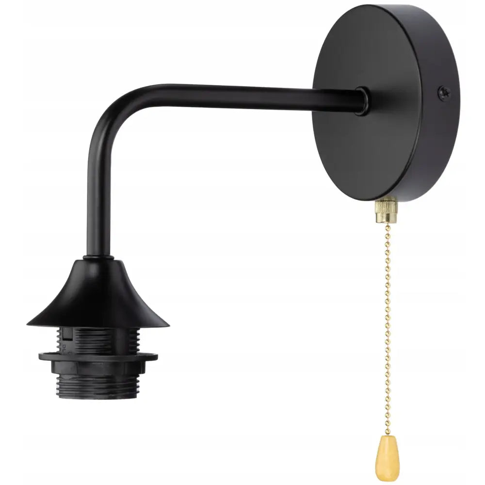 Vegglampe i svart metall, sidevisning med gullfarget trekk-kjede og dråpeformet gul ende, uten lyspære.