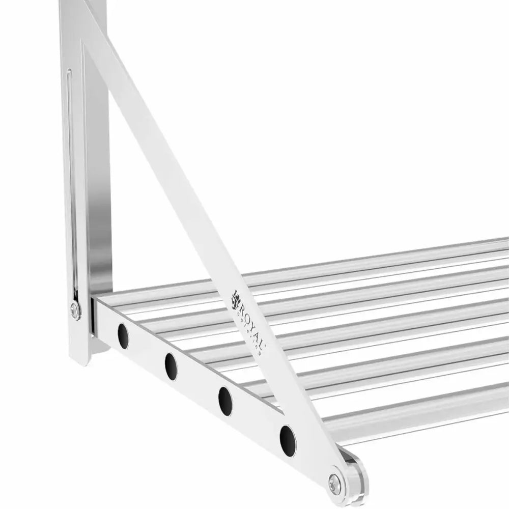 Veggmontert rustfri foldbar hylle, sidevisning med runde stenger og sorte detaljer mot hvit bakgrunn.