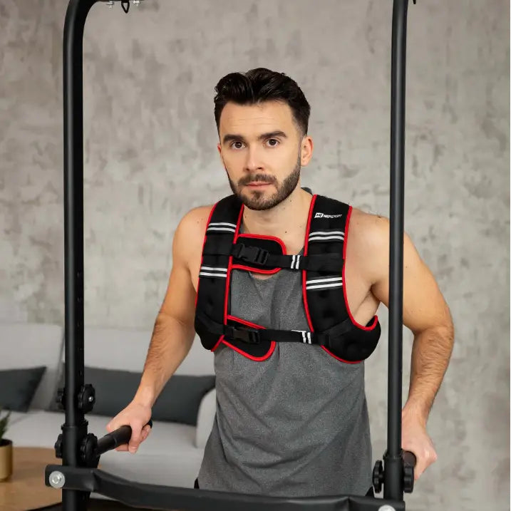 Vektvest 10kg brukt av mann i grå singlet, frontvisning under trening på apparat med vertikale håndtak.