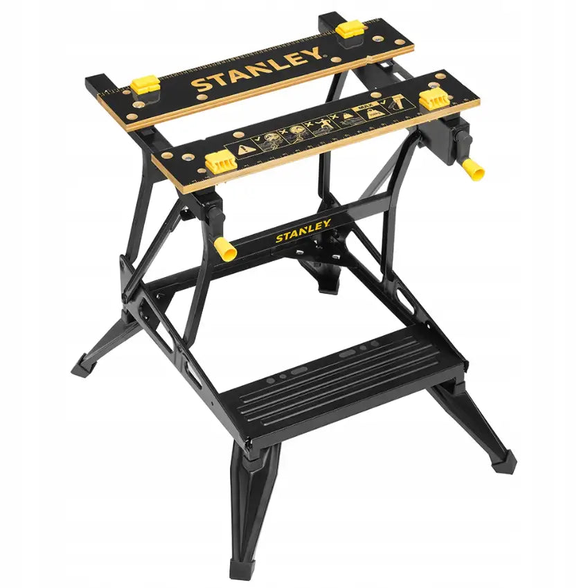 Verkstedbord 2 i 1, skrå oversiktsvinkel som viser måleskala, sikkerhetssymboler og gule justeringshåndtak.