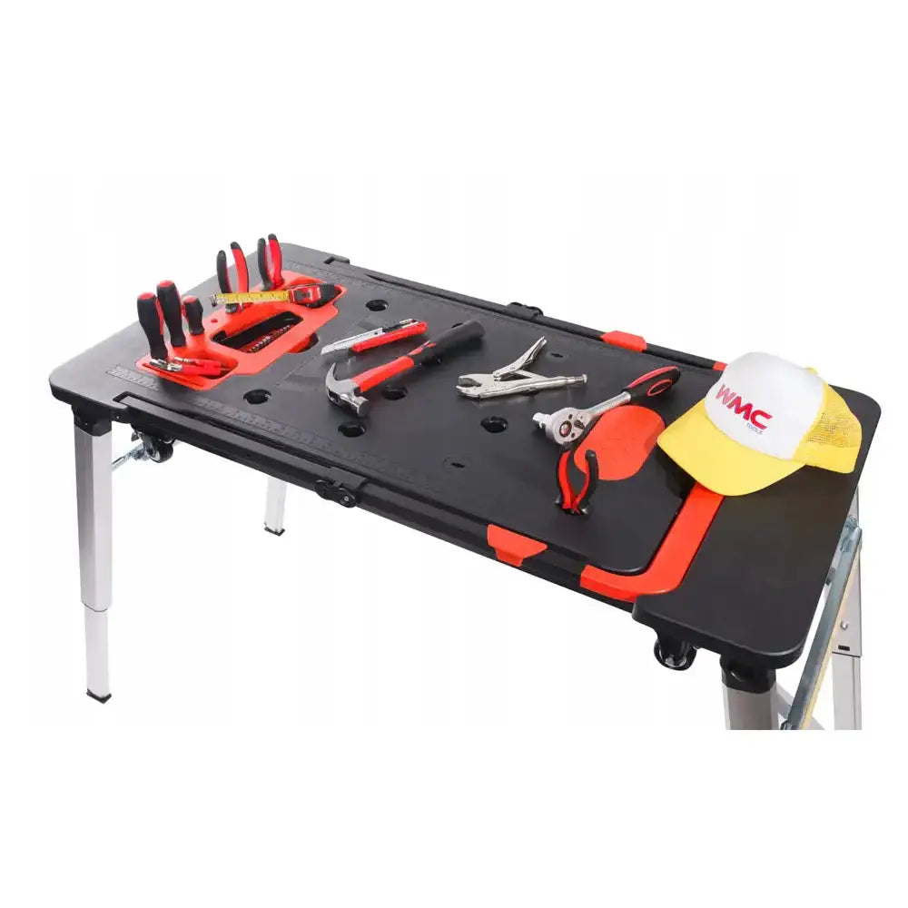 Verkstedbord Universal Multifunksjonell 7 i 1, skrå oversikt med håndverktøy og gul caps på sort arbeidsflate.