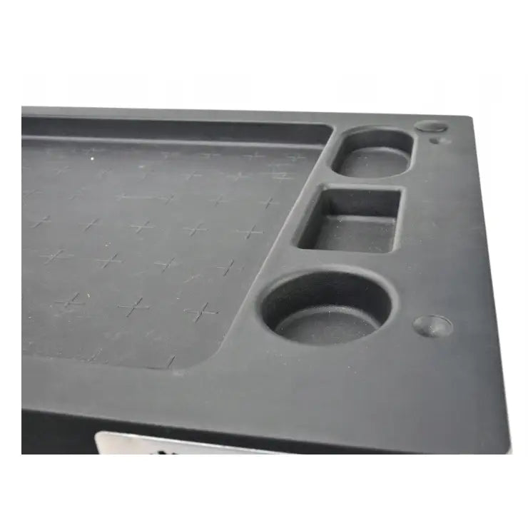 Verkstedsvogn med 7 skuffer, nærbilde av svart plastoverflate med struktur og sirkulære rom for verktøy.