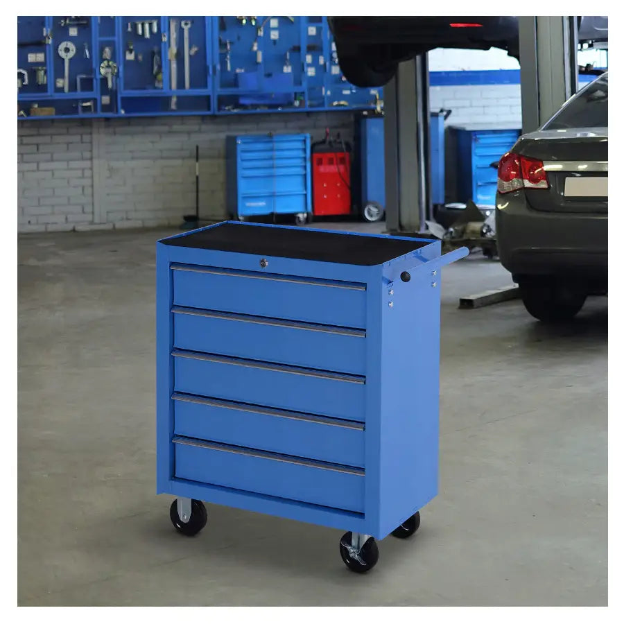 Blå verktøyskapvogn med fem skuffer og hjul, sett skrått i bilverksted, håndtak på høyre side.