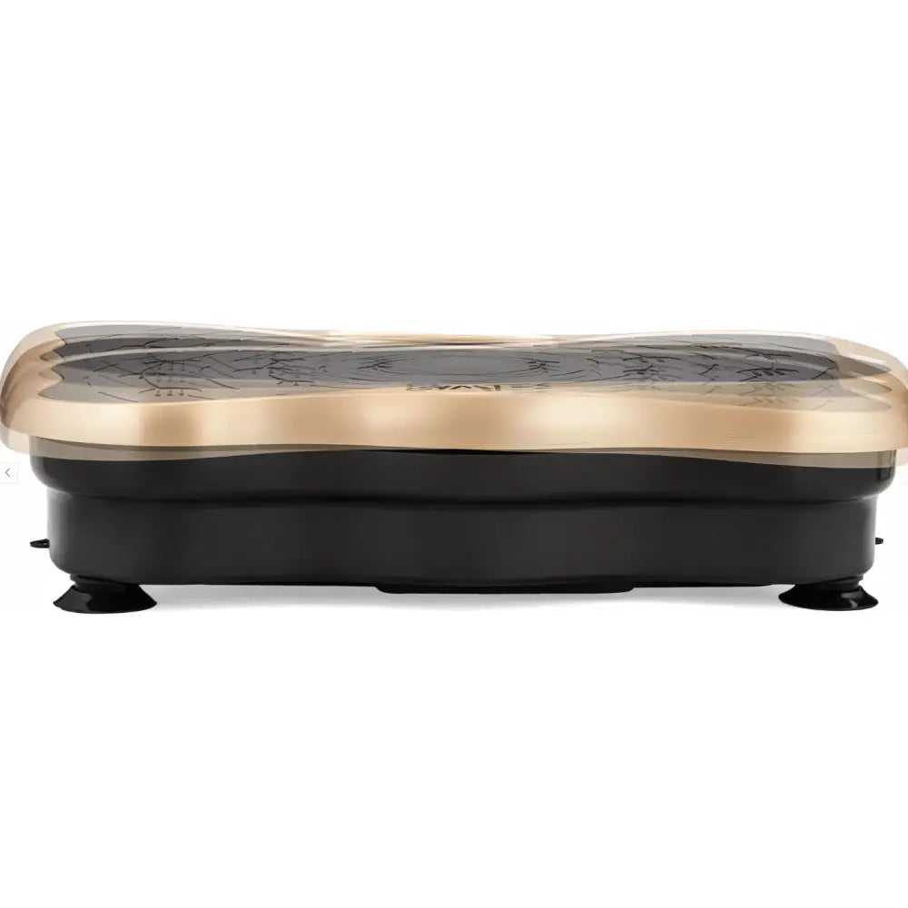 Vibrasjonsplattform trening massasjeren fra siden, viser sort base, gull topp og stabile gummiføtter på hvit bakgrunn.