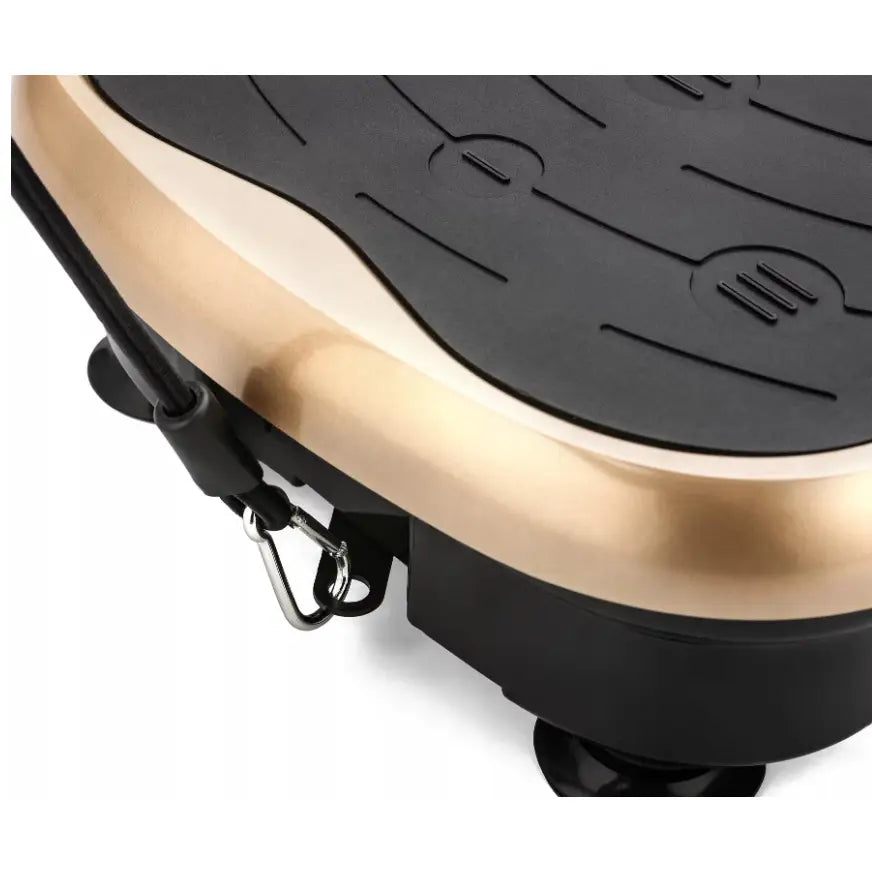 Vibrasjonsplattform, detaljvisning av sort strukturert overflate, gullfarget ramme og synlig strikkfeste.