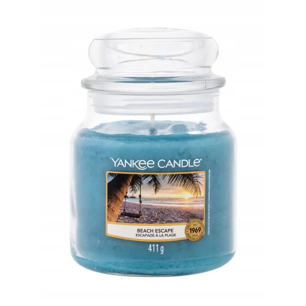 Yankee Candle Beach Escape duftlys i blå glasskrukke, frontvisning med strandmotiv og synlig etikett.