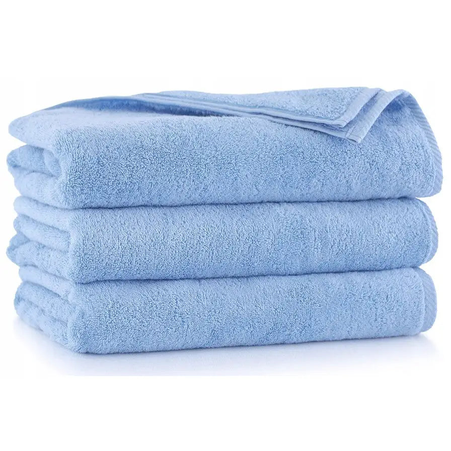 Zwoltex Tykke Kiwi lyseblå håndklær, tre myke frottéhåndklær pent stablet fra siden mot hvit bakgrunn.