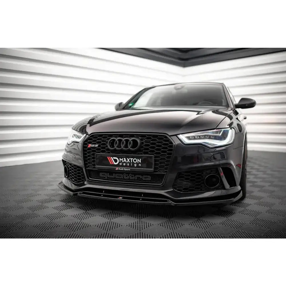 Audi A6 (C7) 11-18 - Deler Og Tilbehør, sort Audi med markant grill og LED-lys sett forfra i moderne omgivelser.