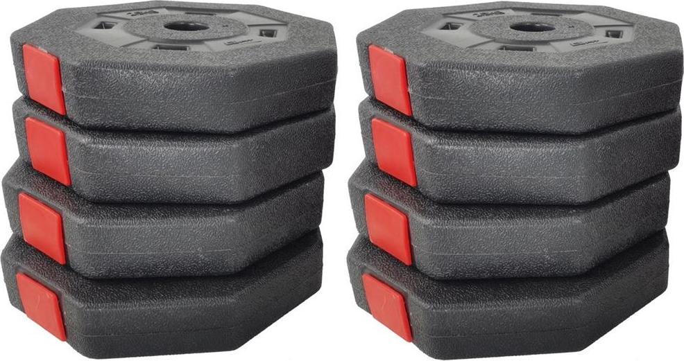 Manualer Sett med åtte sekskantede sorte vektskiver med røde detaljer, stablet i to like høye stabler.