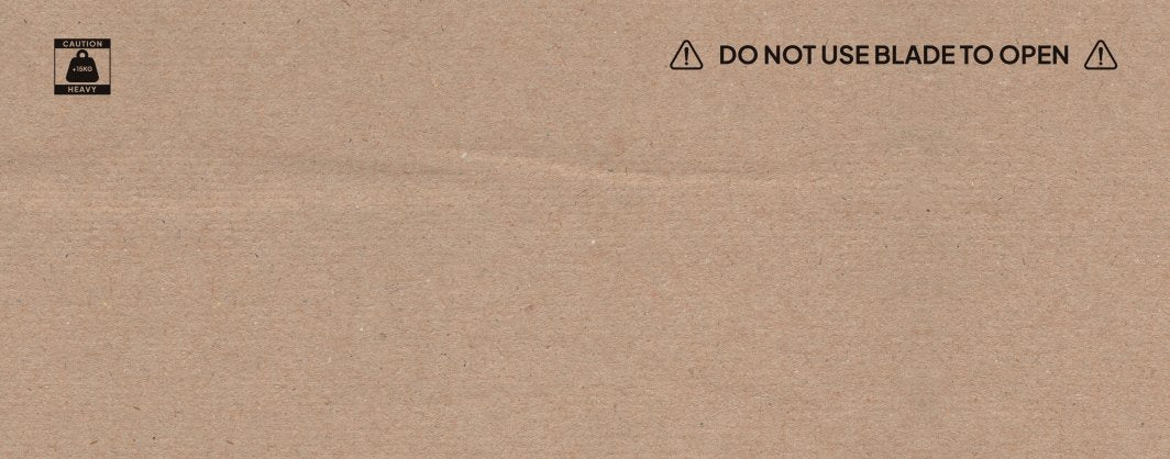 Ellipsemaskin i brun pappeske med svart trykk, advarsel mot knivbruk og vektmerking på 18 kg vises tydelig.