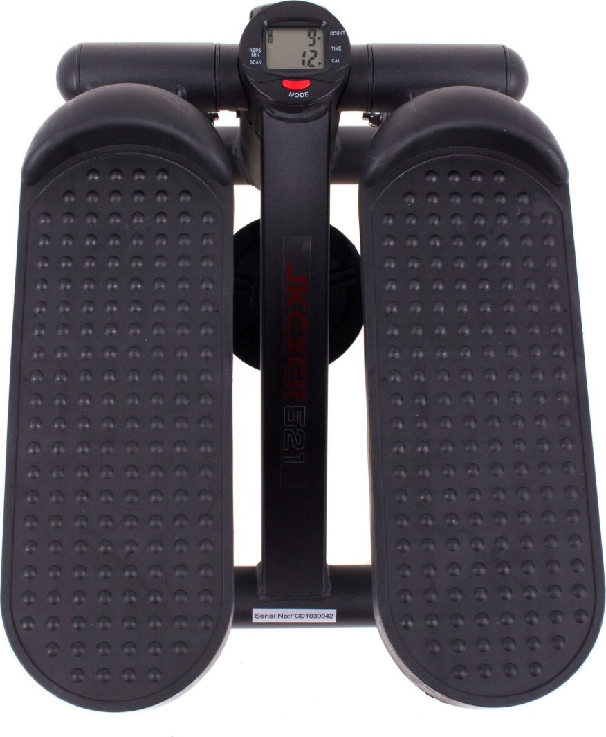 Mini Stepper i sort plast og metall, to brede pedaler med knotter, digital skjerm og knapp i midten, sett ovenfra.