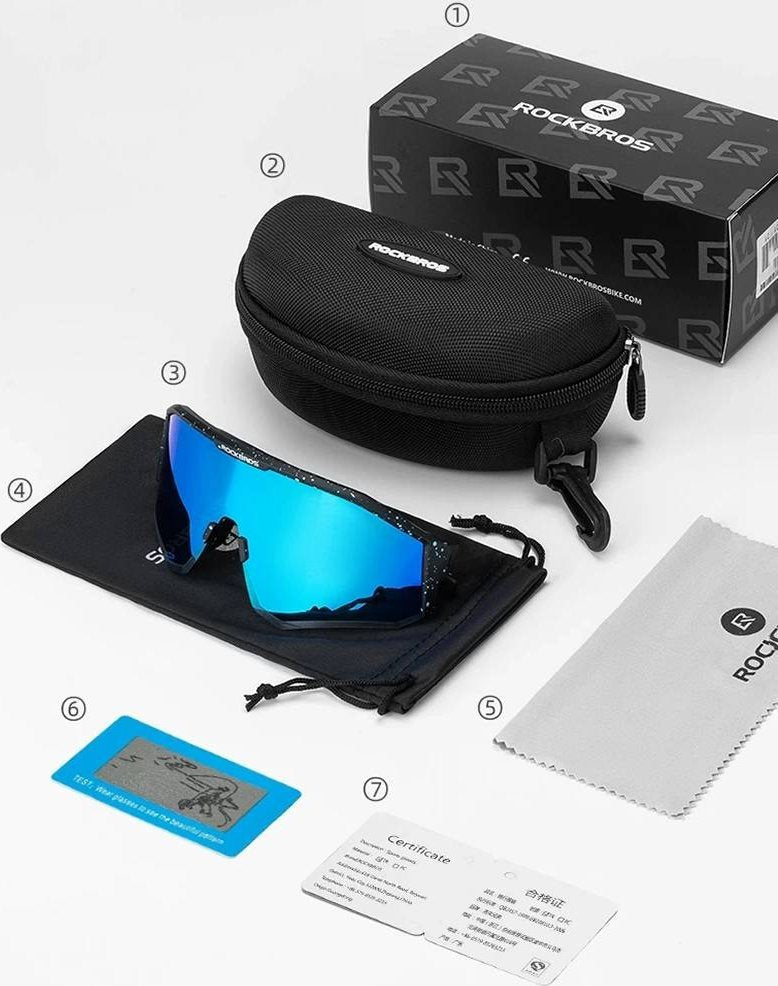 Sykkelbriller Klart Glass med blå speillinse, svart etui, pose, klut, sertifikat og testkort på hvit bakgrunn.