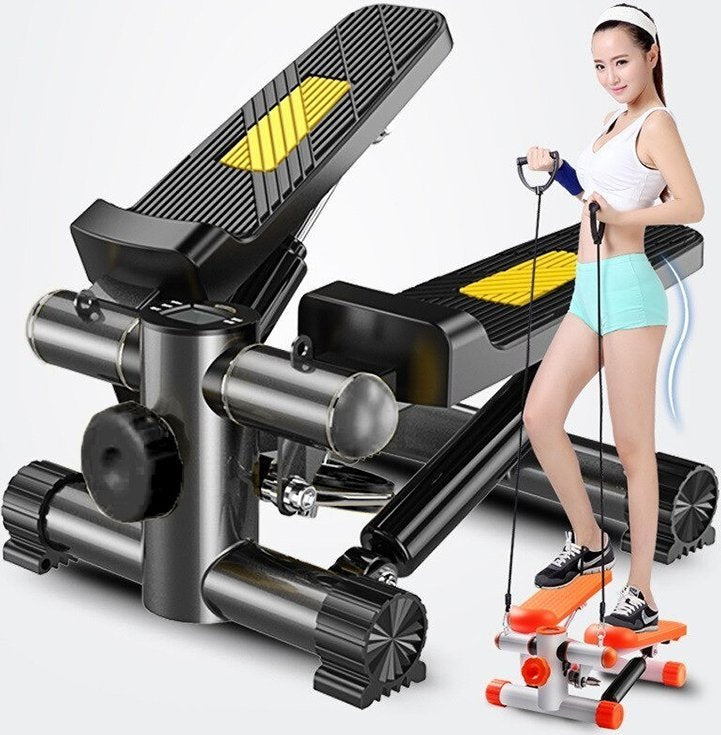 Stepmaskin i sort med gule detaljer brukt av person, viser vrifunksjon og treningsstrikker fra skrå vinkel.