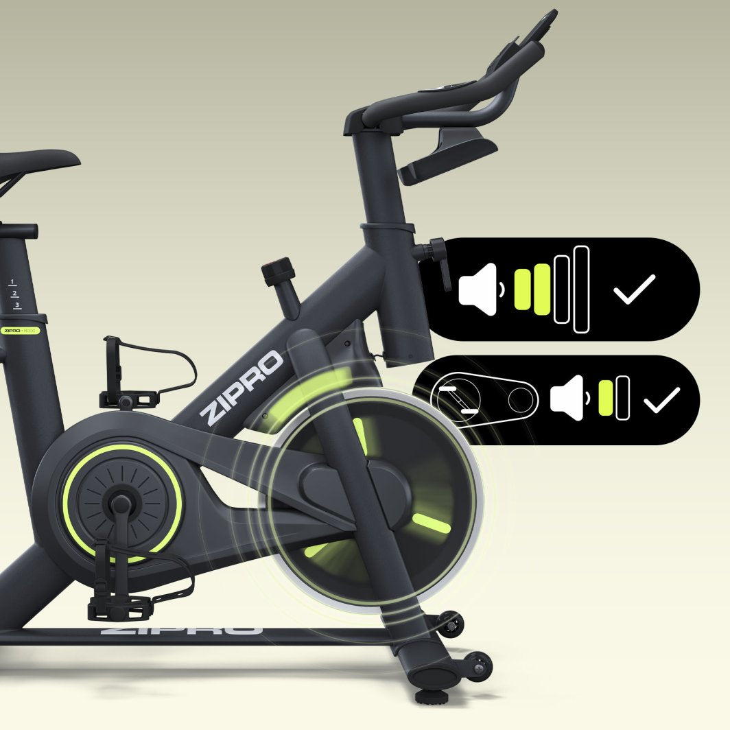 Spinningsykkel i sort med neonfargede detaljer, sett fra siden, viser stillegående funksjon og bevegelig svinghjul.