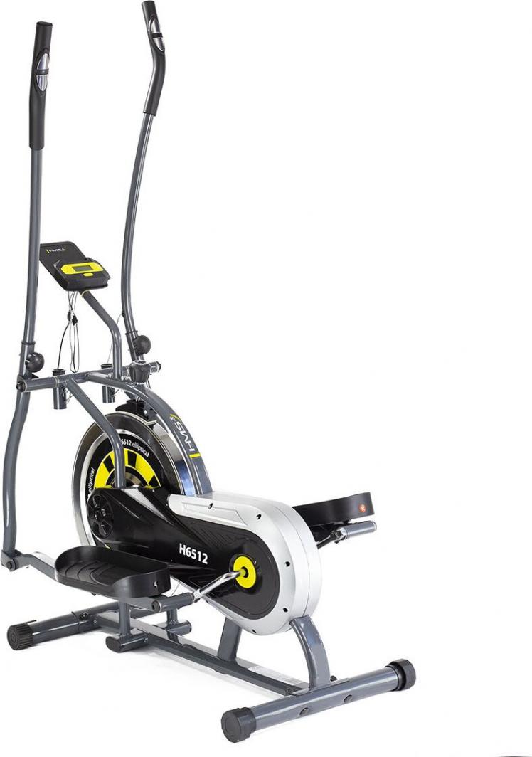 Ellipsemaskin i grått, svart og gult sett fra siden med store håndtak, bred base, pedaler og displaypanel.