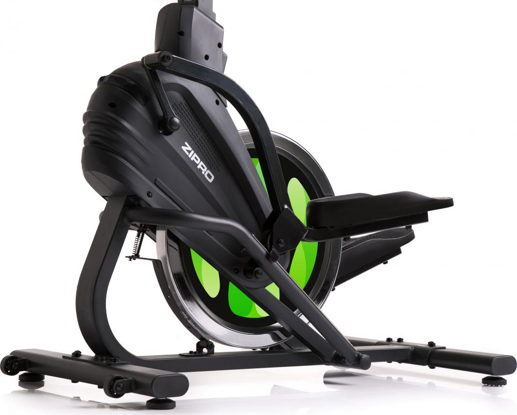 Crosstrainer med sort ramme, grønt svinghjul, synlige pedaler og sete, avbildet fra siden mot hvit bakgrunn.