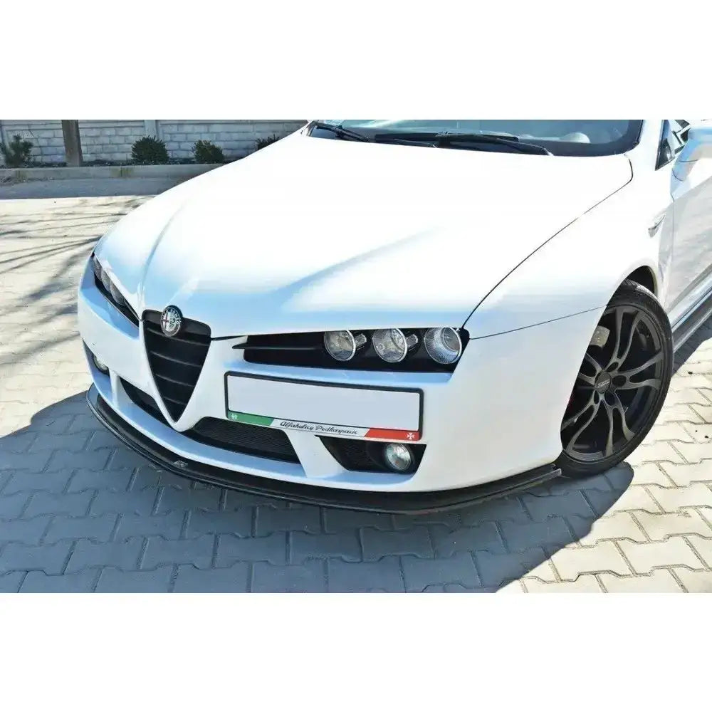 Frontspoiler på Alfa Romeo Brera i hvitt med svart spoilerleppe og sorte felger, sett skrått forfra.