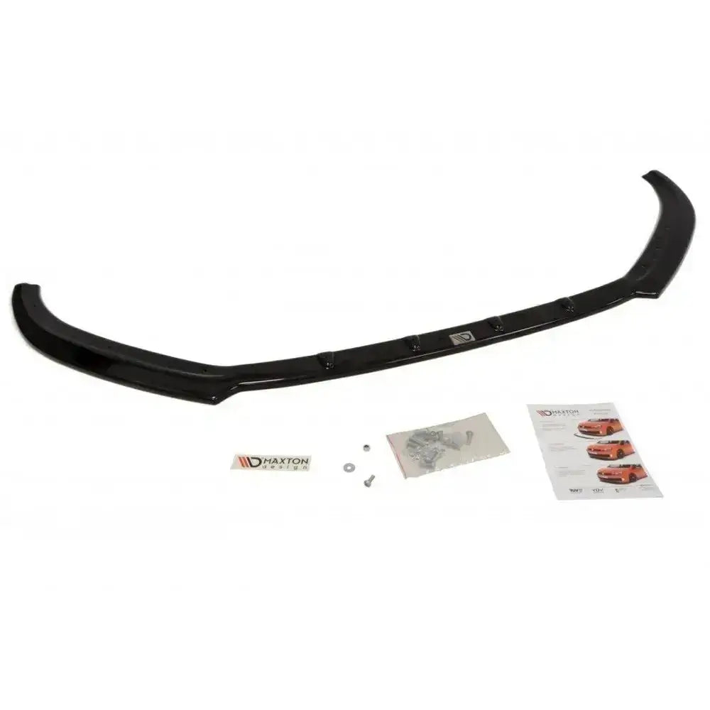 Frontsplitter til Audi A1 preface modell i blank sort plast med monteringssett og instruksjoner ved siden av.
