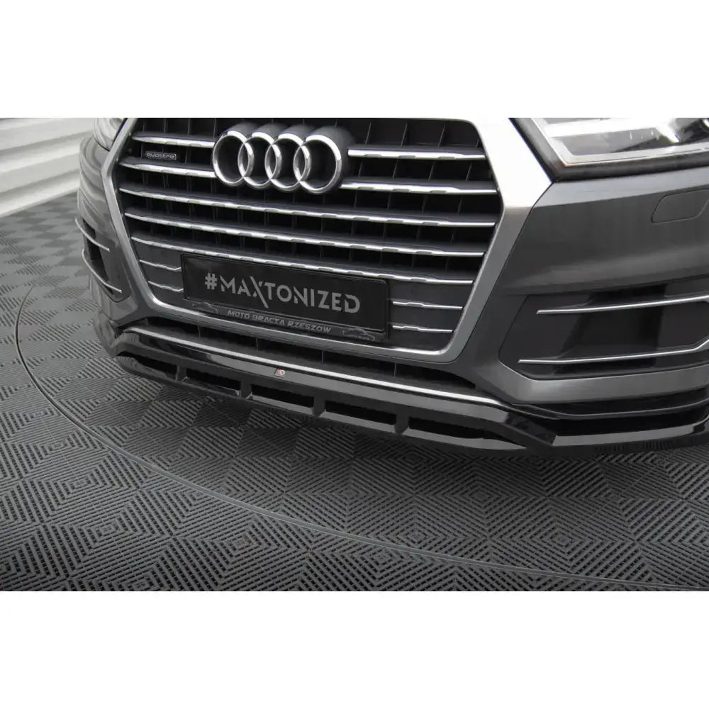 Front lip Audi Q7 Mk2 sort frontsplitter sett forfra med luftinntak og krom grill på grå bil.