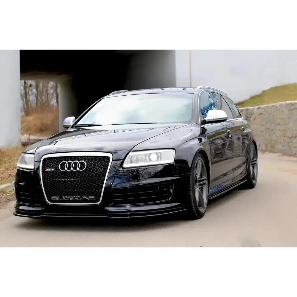 Front lip Audi RS6 C6 på sort stasjonsvogn med sølv speilhus og RS6- og quattro-emblemer.