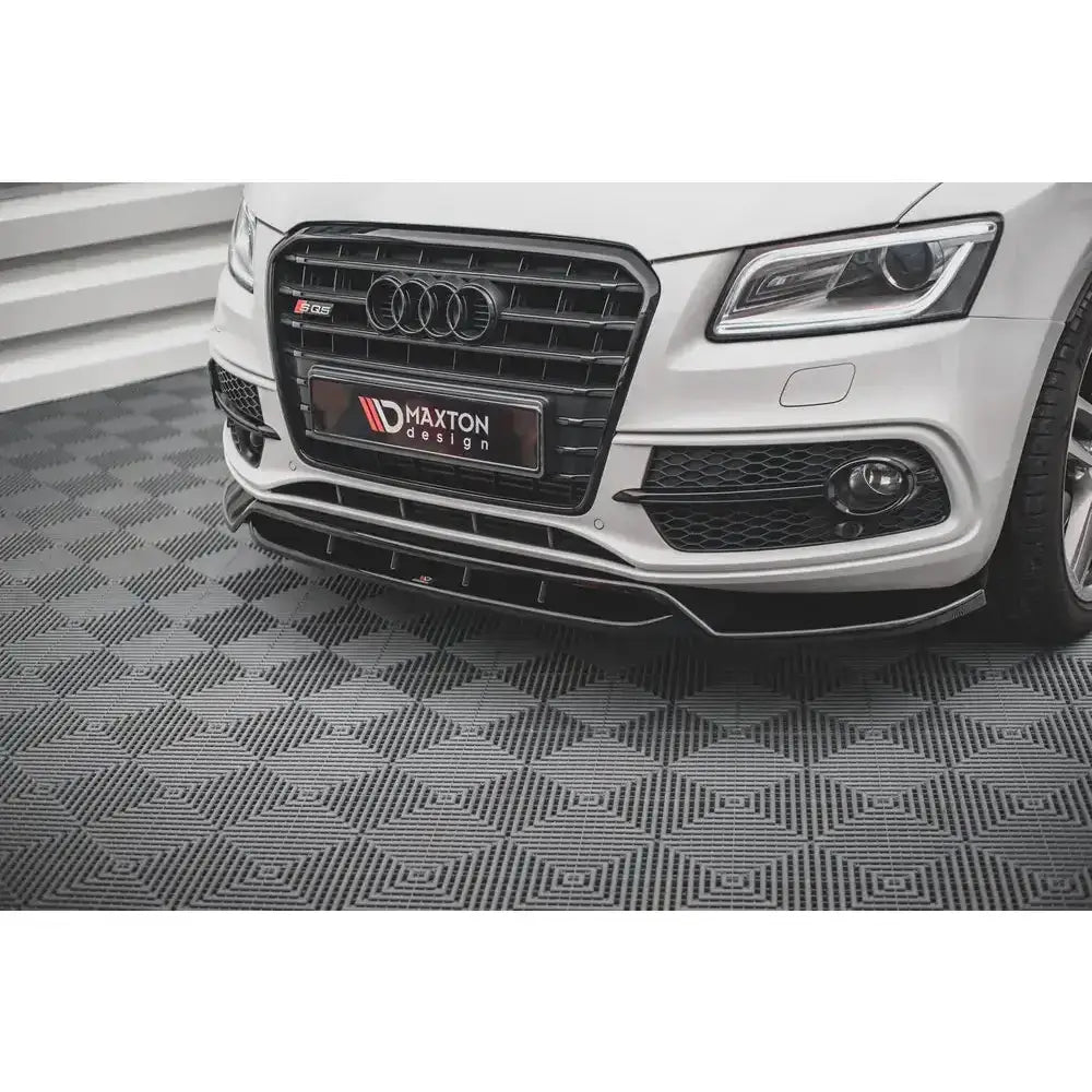 Frontsplitter Audi SQ5 Mk1 vist montert under støtfanger på hvit bil med kromdetaljer i grillen.
