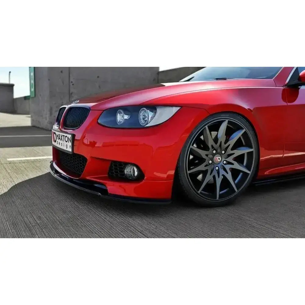 Front lip på BMW 3 E92 Mpack med blank sort frontspoiler og svarte felger, sett forfra i lav vinkel.